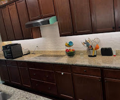 Kitchen with under-cabinet lighting and finished electrical details